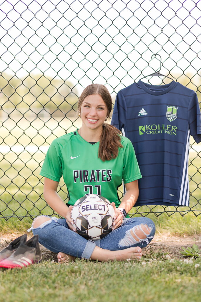 senior girl with her sports jerseys