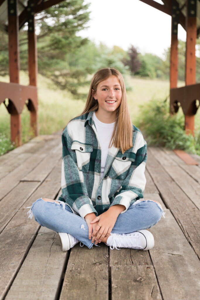 senior girl sitting crosslegged