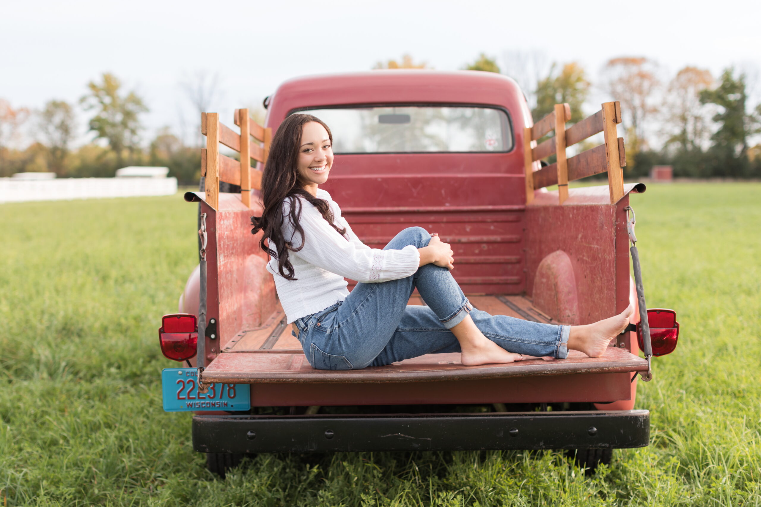 senior girl sitting in the back of a truck