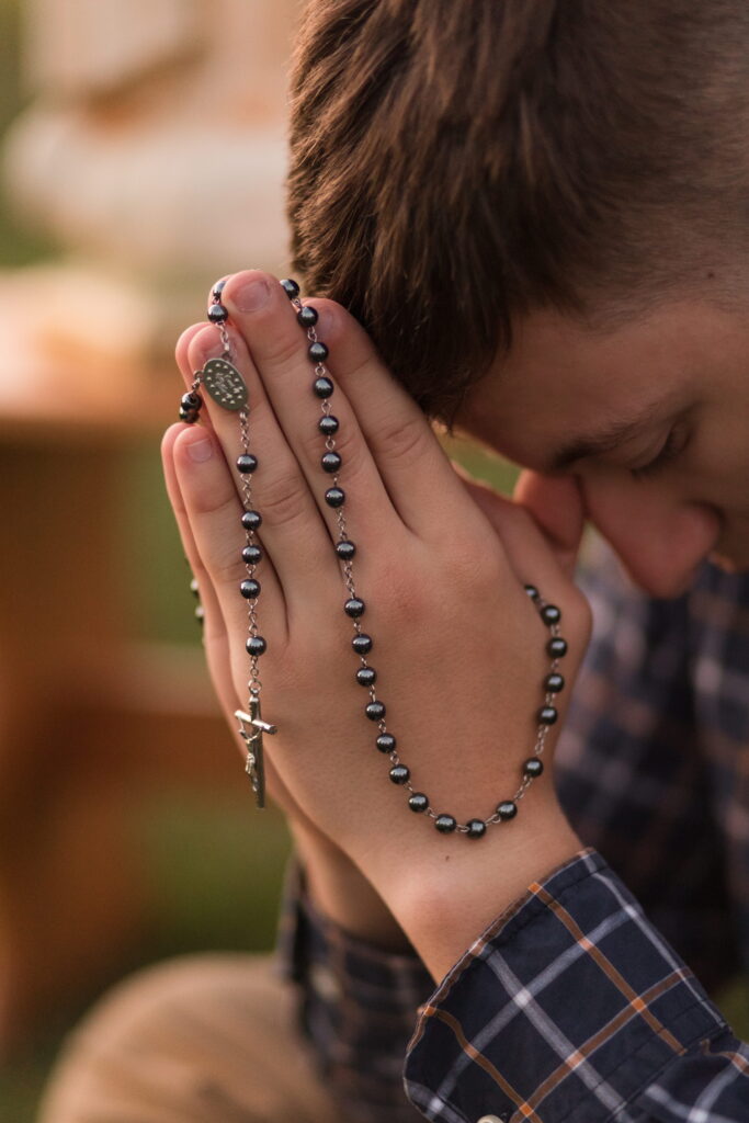 senior guy praying the rosary