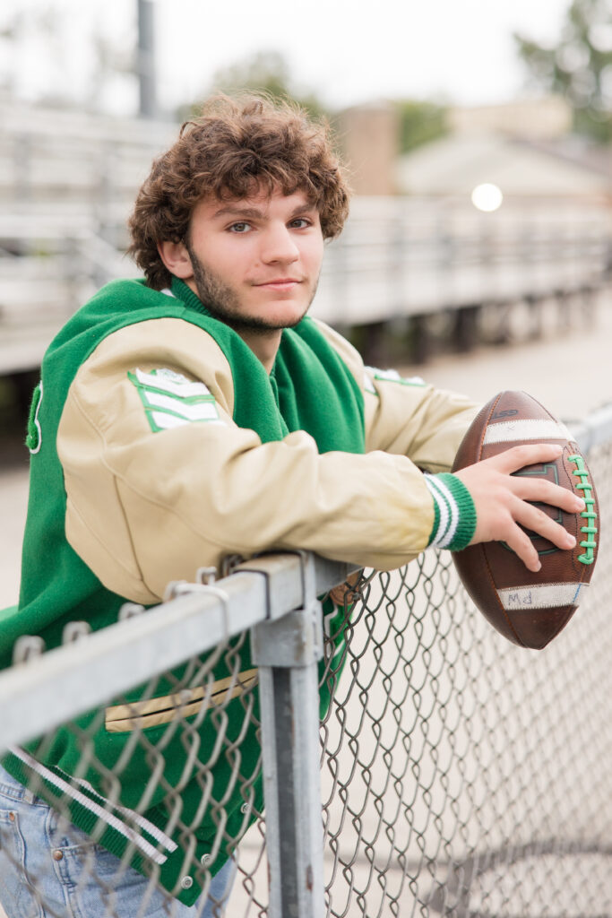 senior guy with a football