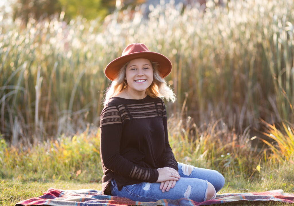 senior girl in front of long grass