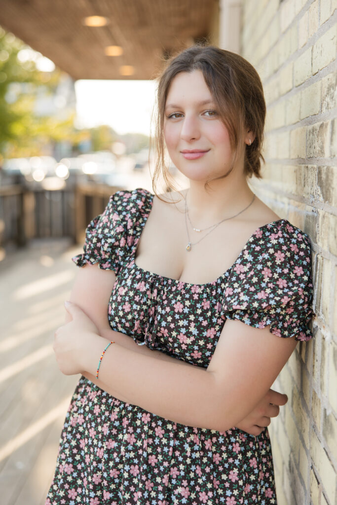 senior girl leaning against a building