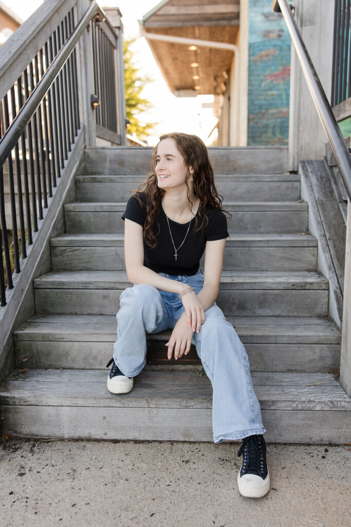 Senior girl seated on some stairs