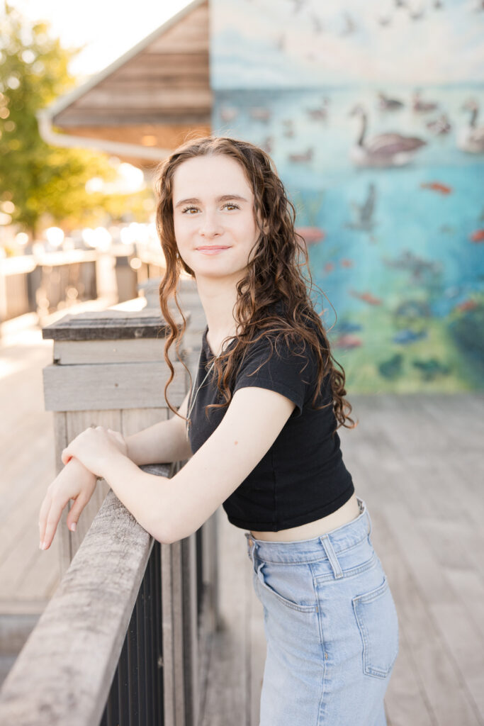 Senior girl leaning against a rail