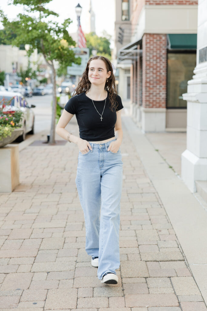 Senior portrait session in Port Washington, Wisconsin of girl walking along the sidewalk